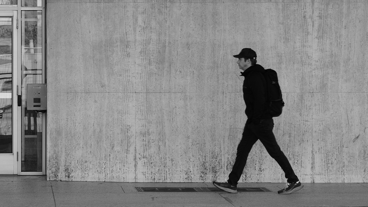 Person walking through a city during the day as part of a daily routine